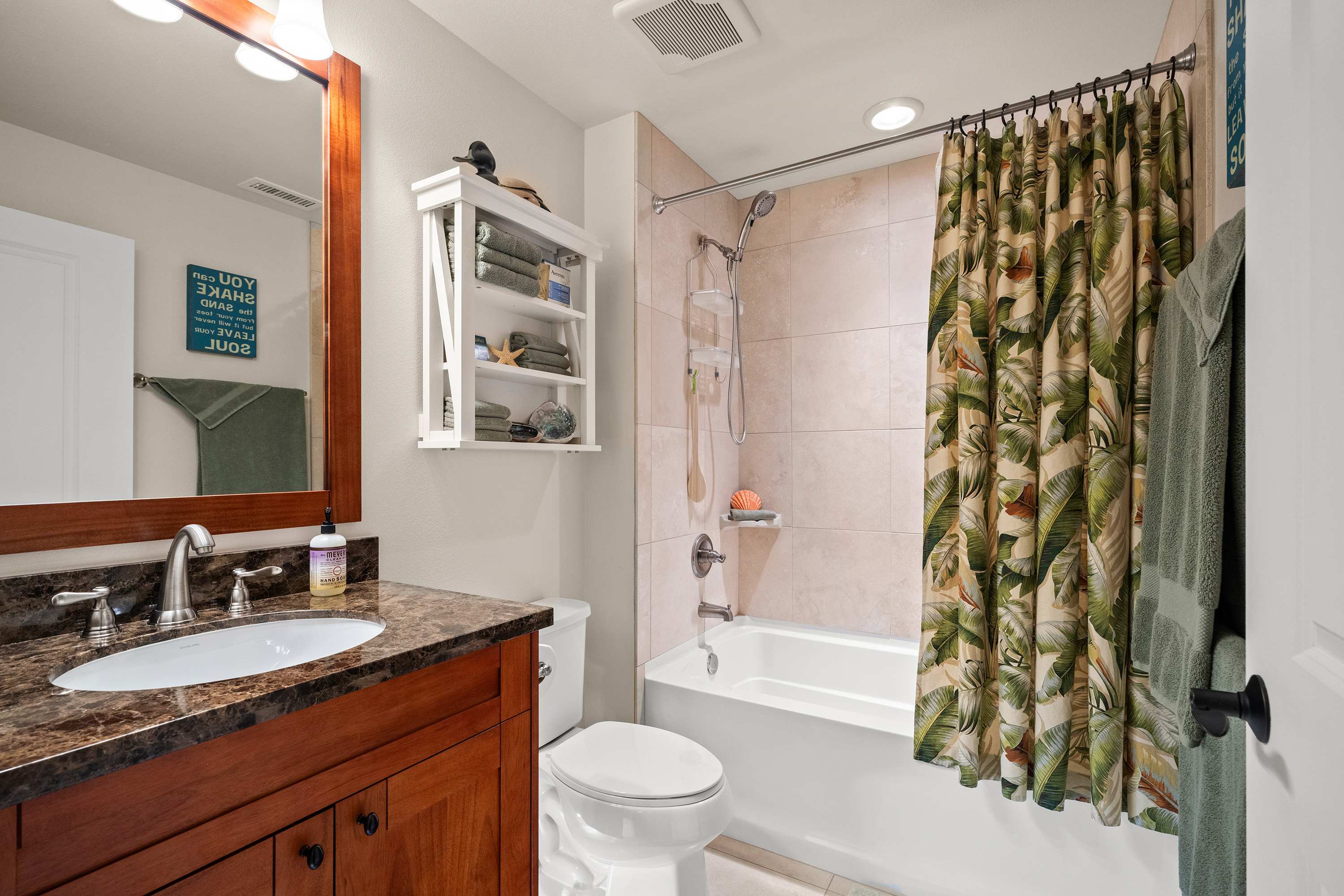 Bathroom with wood vanity and tub