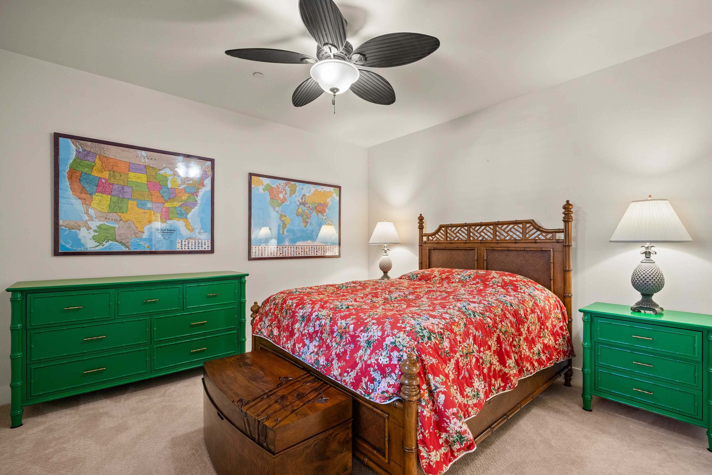Bedroom with tropical quilt and map artwork
