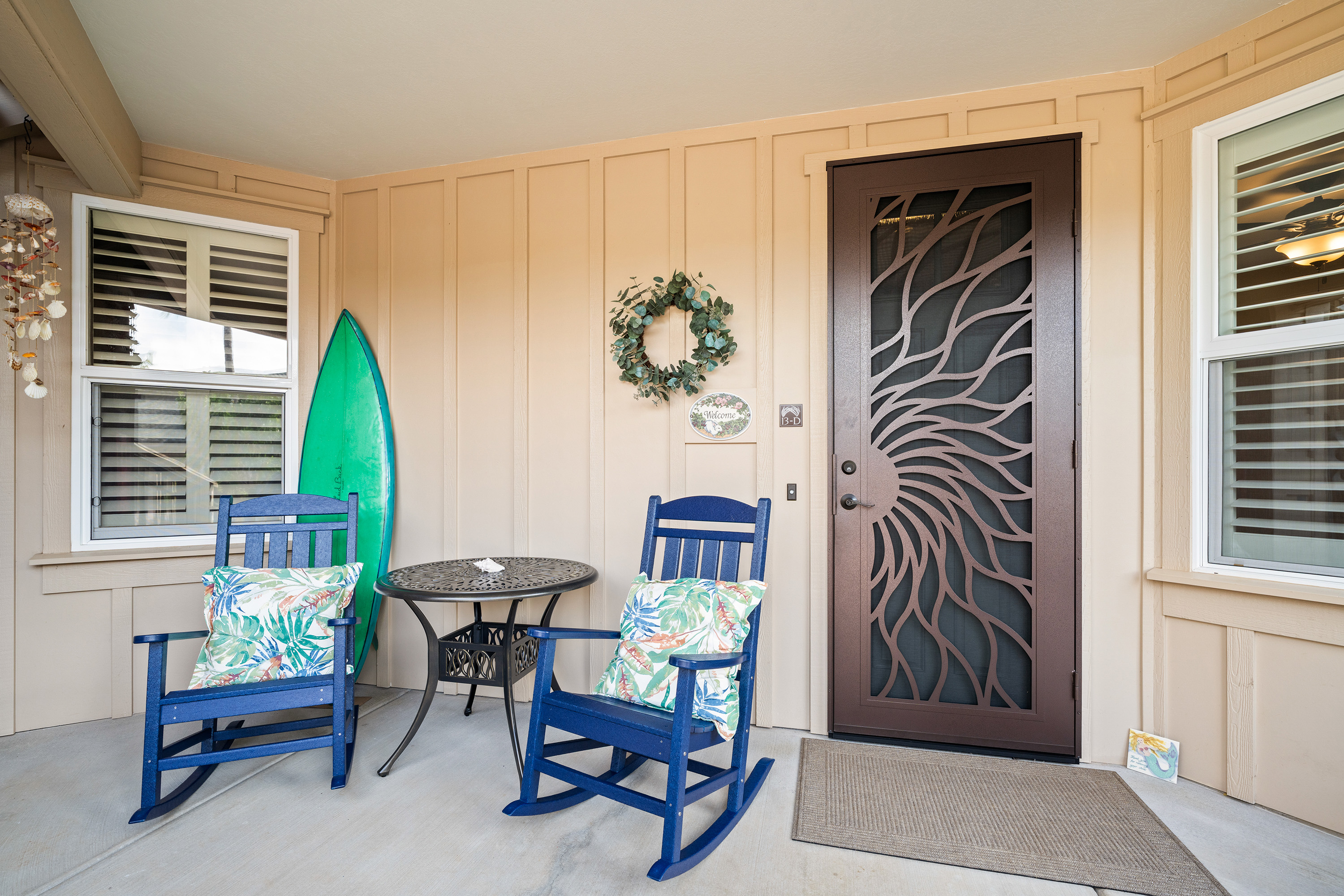 Front porch with rocking chairs and surfboard