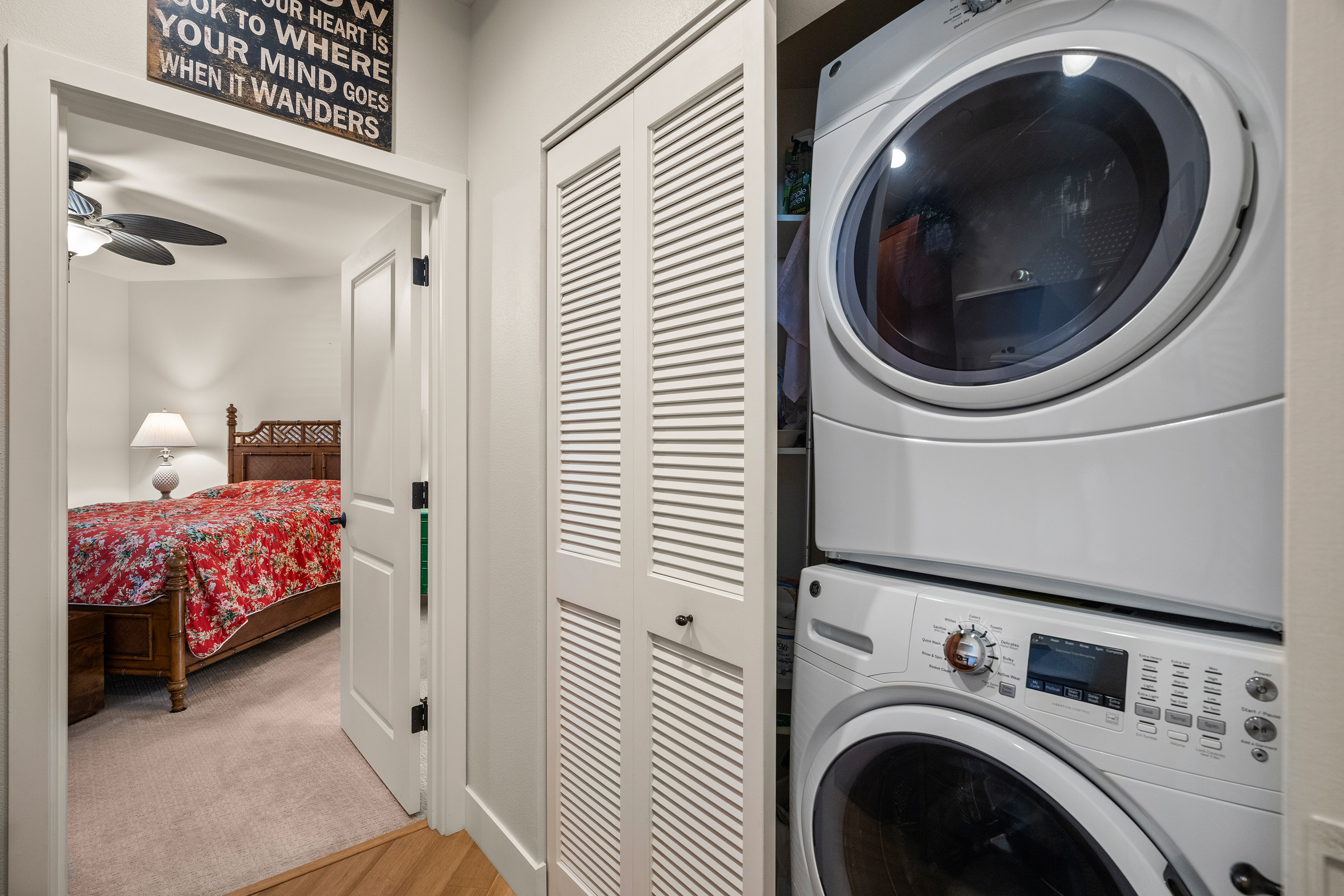 Hallway closet with stacked washer and dryer