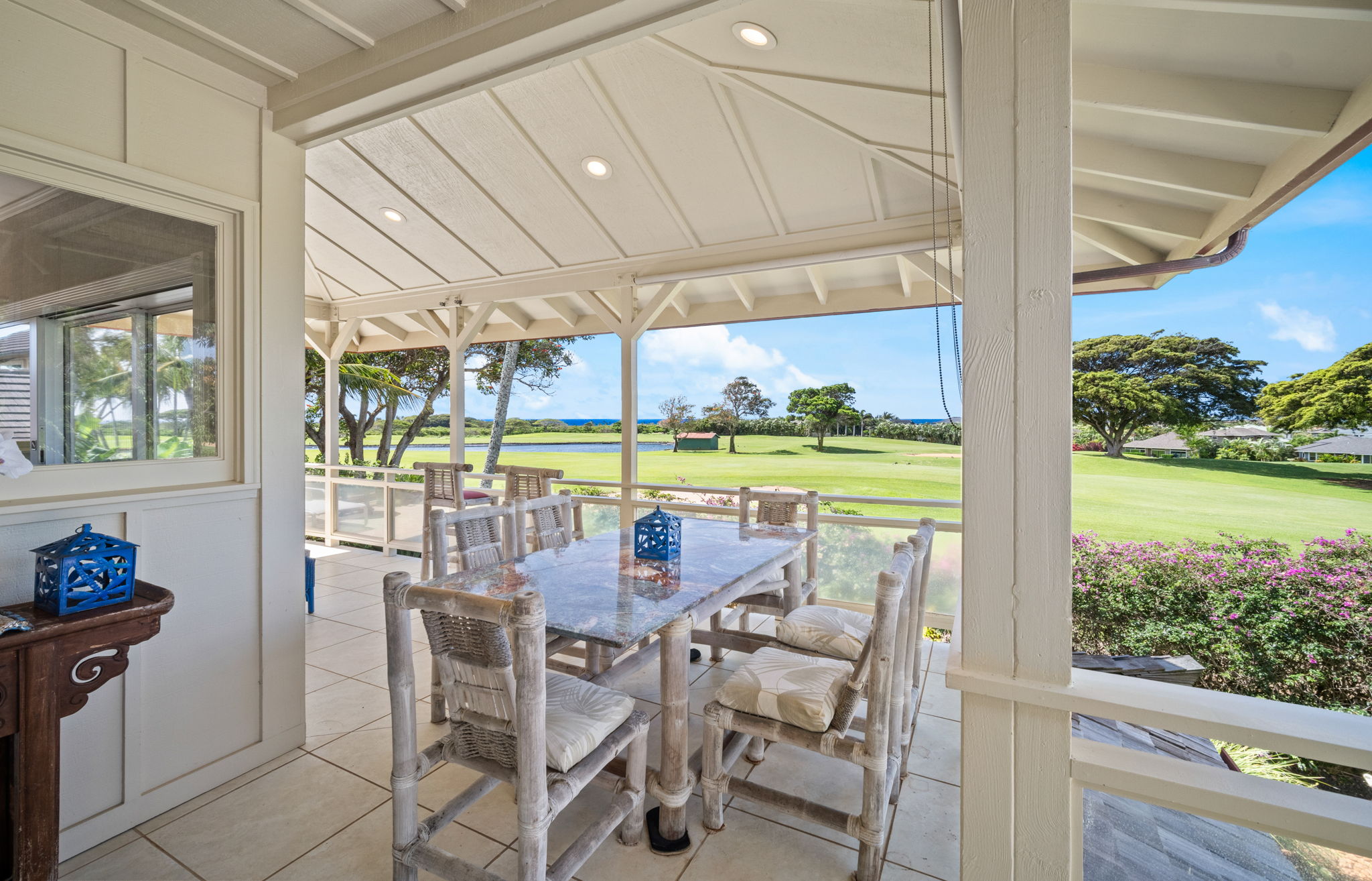 Covered lanai with panoramic golf course and ocean views