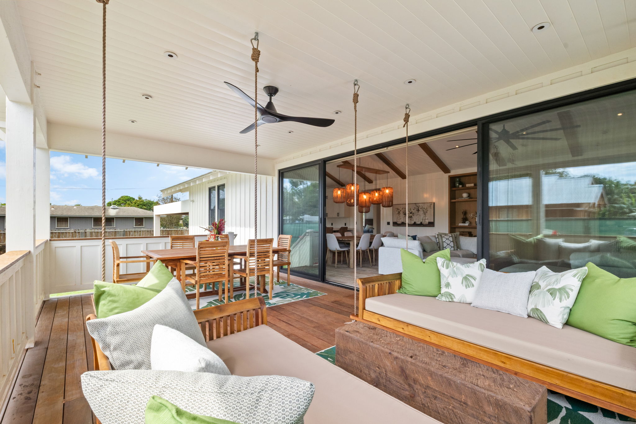 Covered lanai with swing bench and outdoor dining